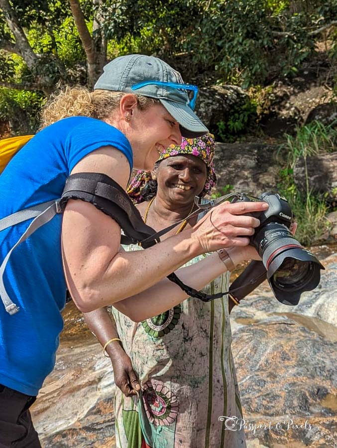 Me taking photos of locals in the Knuckles Mountains and showing the results to the same woman