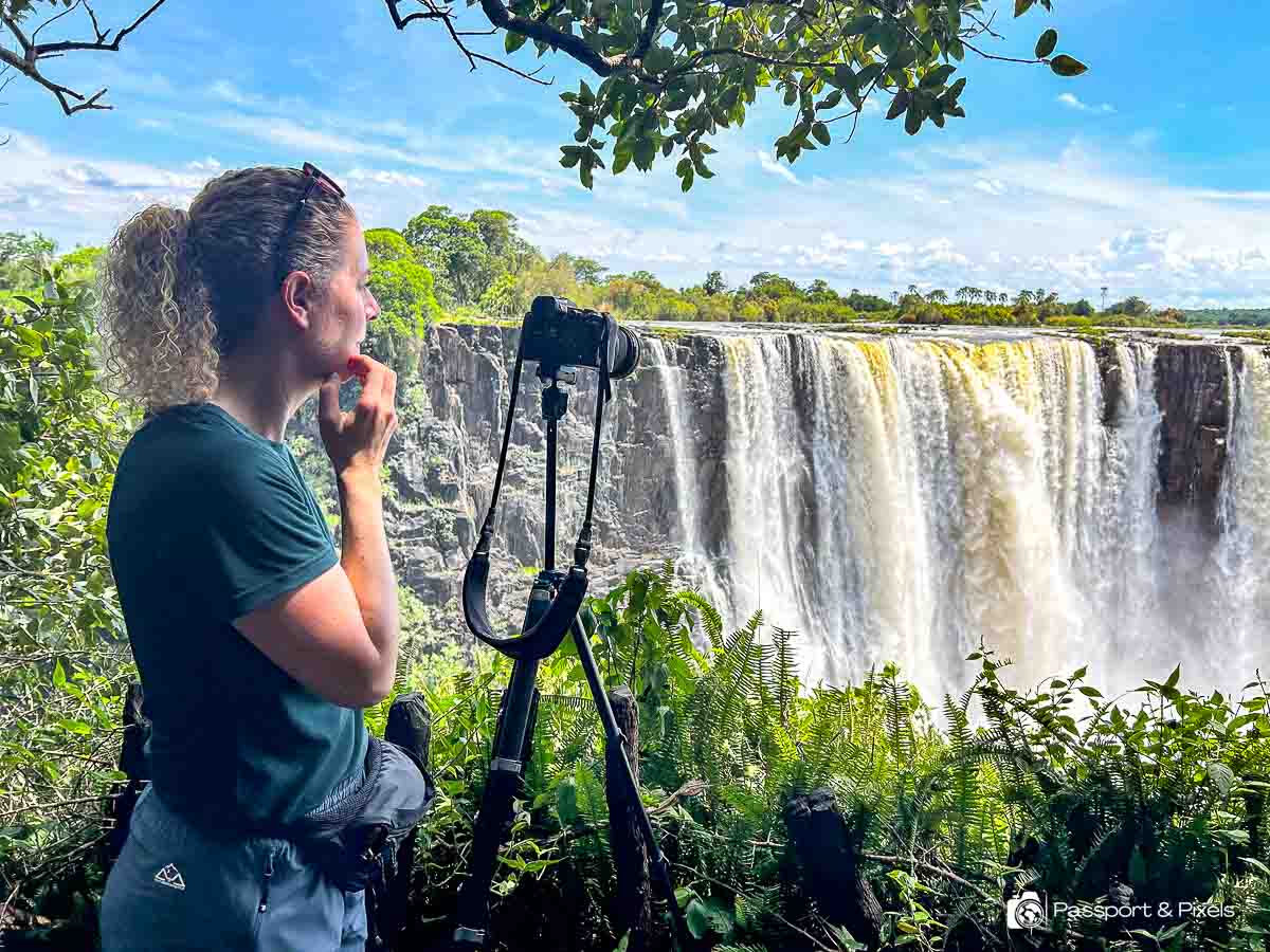 The author (that's me) with a camear on a tripod taking photos at Victoria Falls 