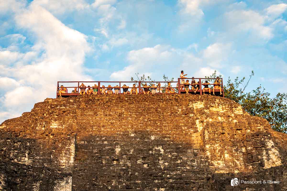 Visitors gather at the top of the Lost World pyramid for sunset at Tikal