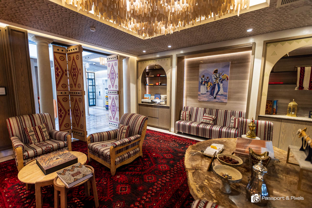 Another lounge with red patterned carpet and Middle Eastern decor